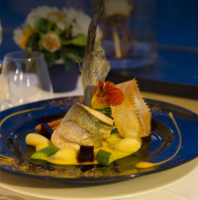 Presentazione elegante di un piatto di pesce del ristorante dell'Hotel