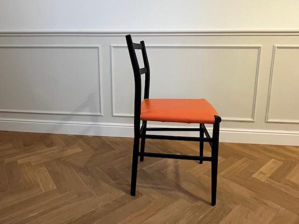 New interpretation Superleggera Chair, orange seat - lateral view. Tribute to Giò Ponti.