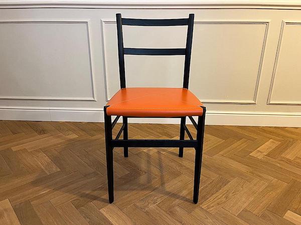 New interpretation Superleggera Chair, orange seat - front view. Tribute to Giò Ponti.